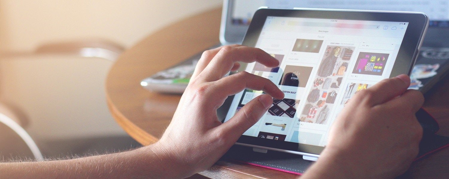 a marketer editing a UX mockup on a tablet